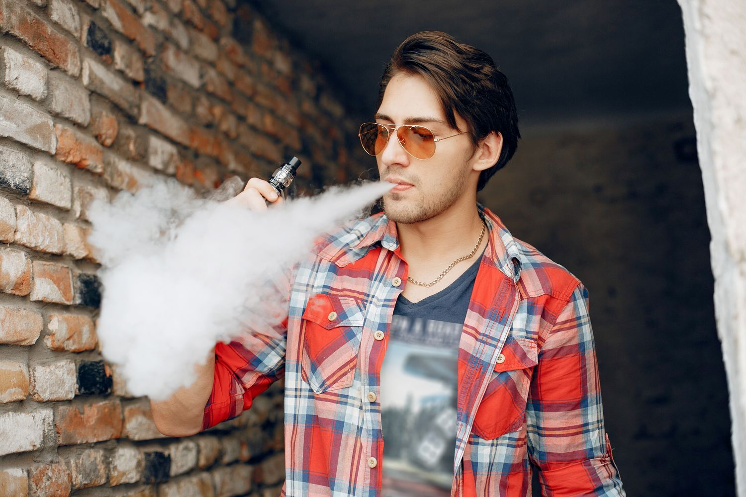 Man enjoying disposable vapes near Renaissance with smoke clouds in the background