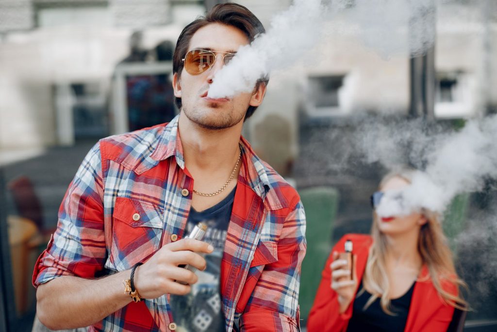 An image of a stylish young couple vaping disposable device near Kendall-Whittier