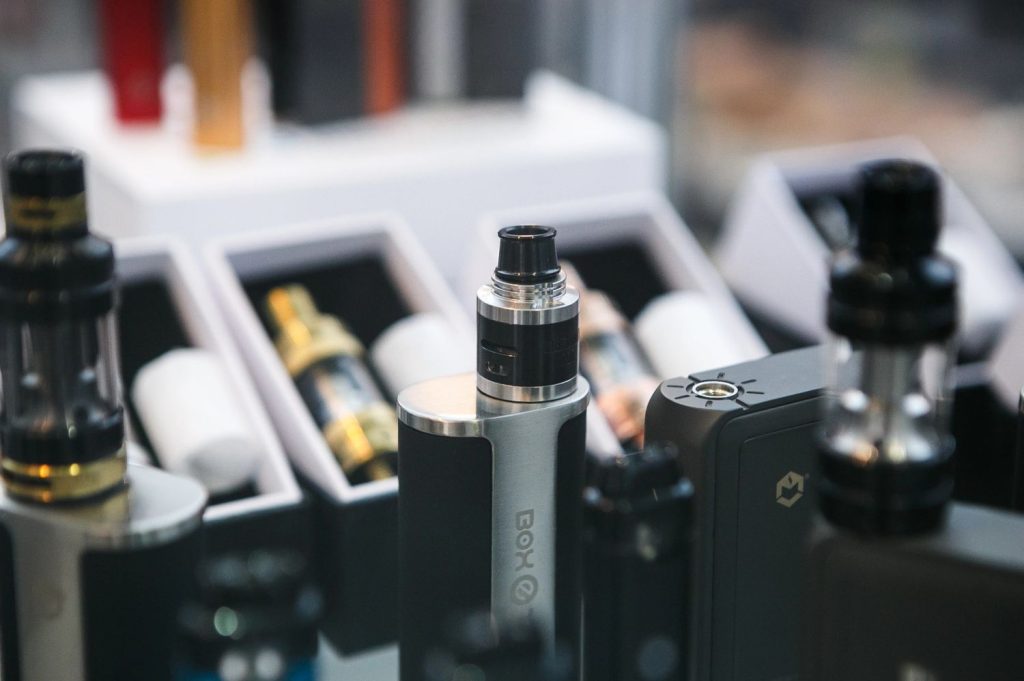 A display of various vape devices at a modern vape shop in Tulsa, showcasing a range of products.