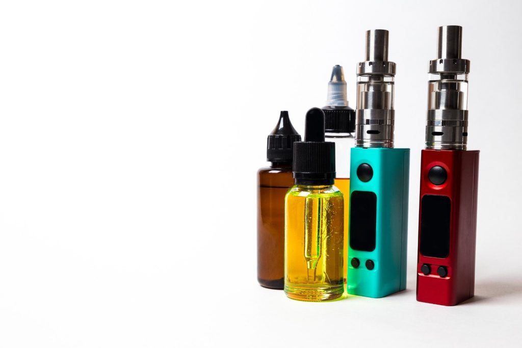 Colorful vape devices and e-liquid bottles displayed at a vape store in Tulsa, offering a range of vaping products.