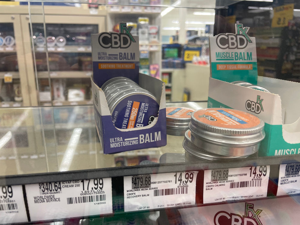 cbd store tulsa cbdfx ultra moisturizing and muscle balms arranged on retail shelf with prices and deep tissue treatment labels