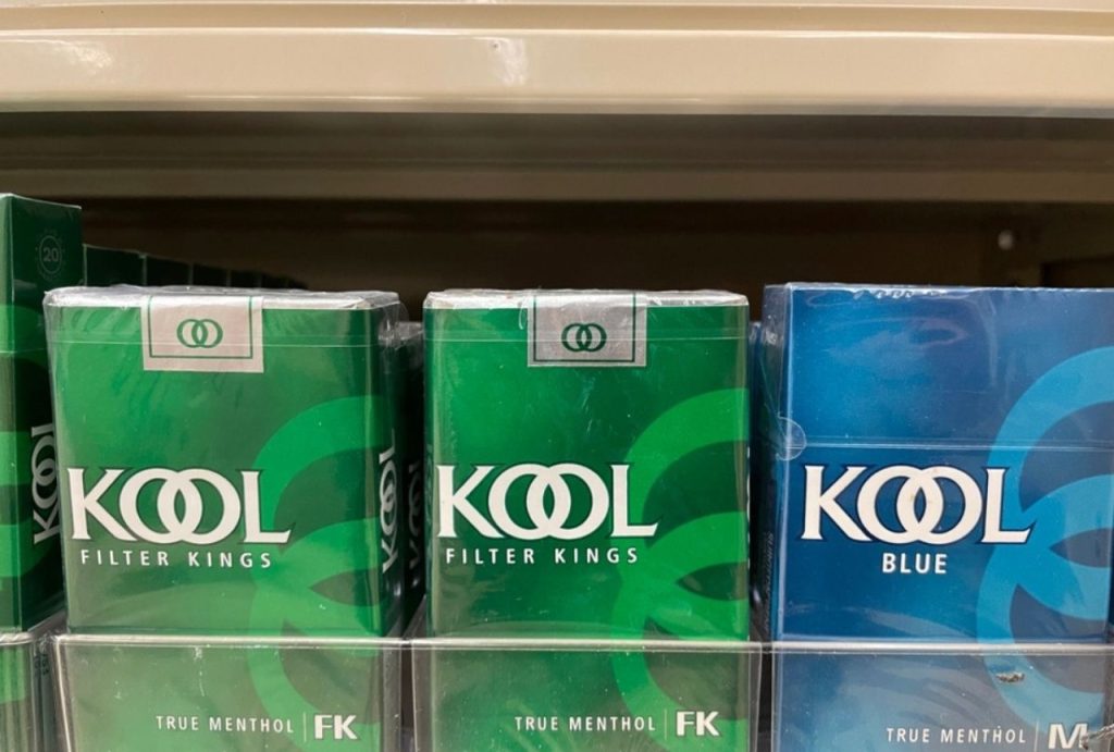 Packs of Kool Filter Kings and Kool Blue menthol cigarettes on a shelf, available at a local cigarette shop Tulsa.