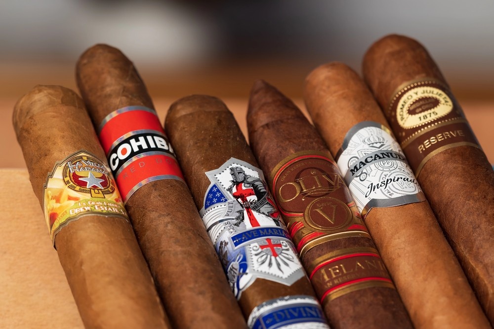 Close-up of premium cigars like Cohiba and Oliva, showcasing the diverse high-end brands at our cigar shop Tulsa.