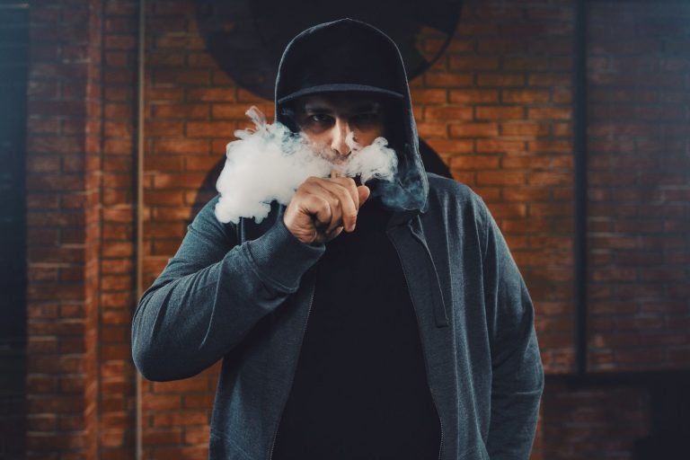 An image of a man smoking a disposable vapes in Tulsa.