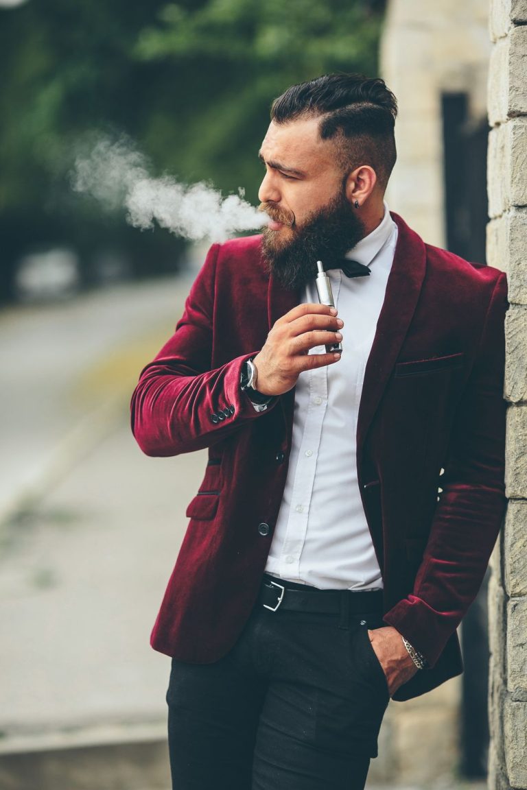An image of a rich man with beard smoking a disposable vape in Tulsa.