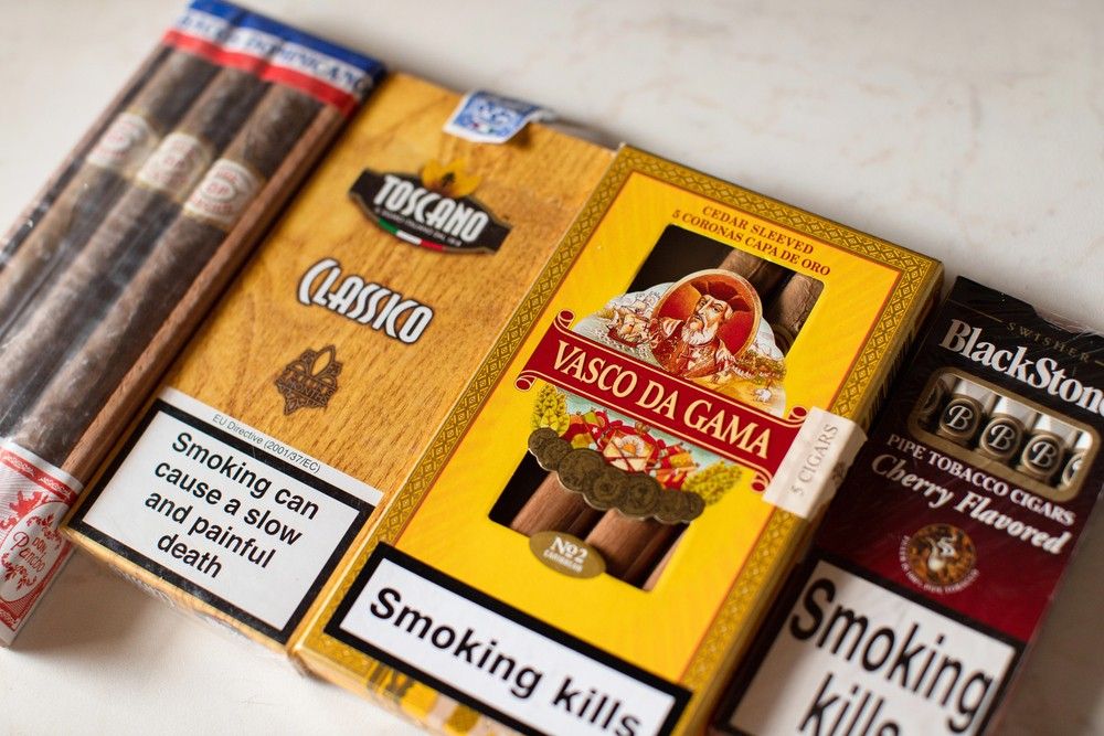 A row of premium cigar packs from brands like Toscano and Vasco da Gama, showing variety available at a cigar shop tulsa.