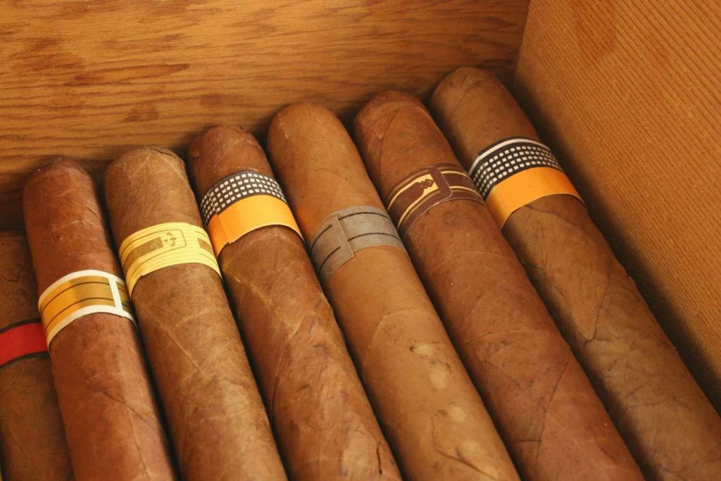 Premium selection of hand-rolled cigars inside a wooden humidor box at a cigar shop Tulsa.