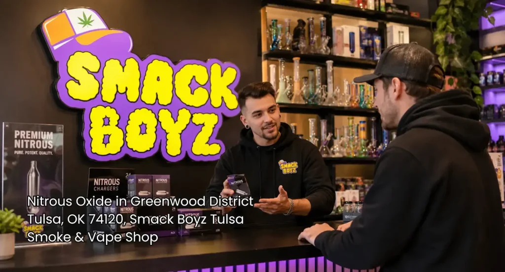 mack Boyz employee assisting a customer with nitrous oxide Tulsa chargers at a clean, organized smoke shop counter.